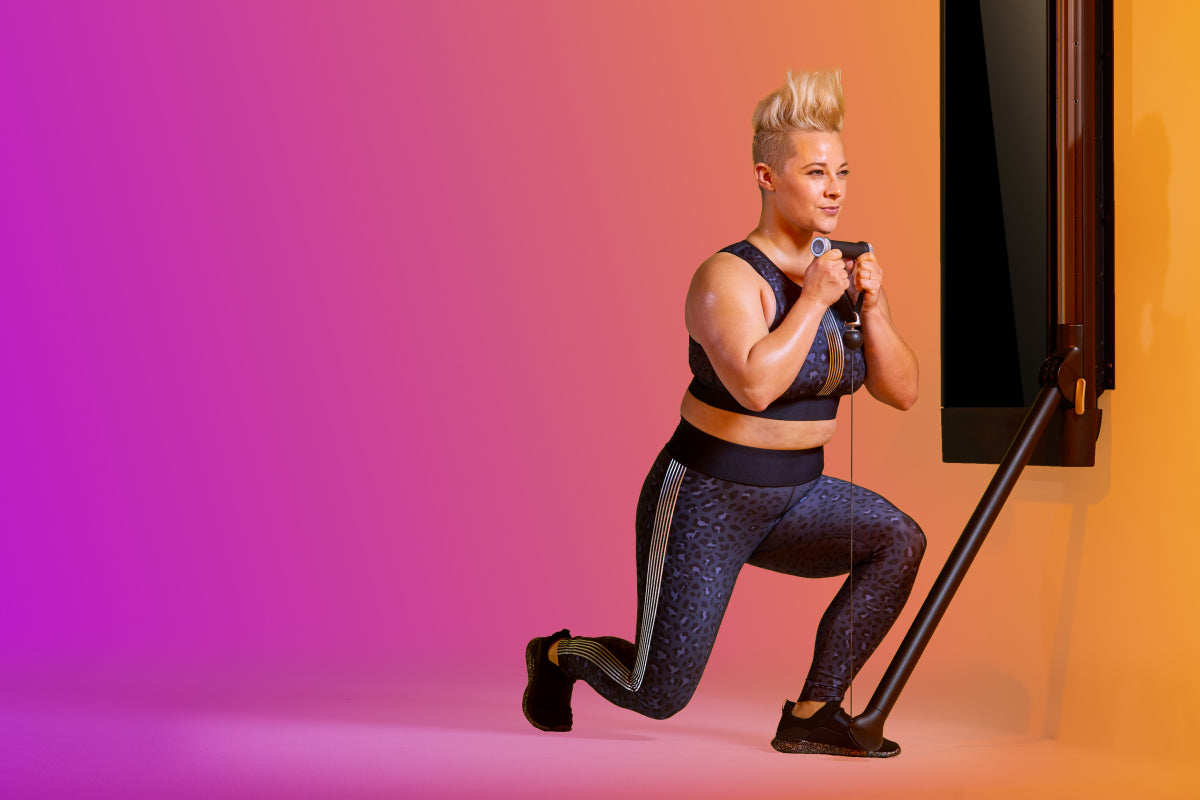 a woman holding a Tonal Smart Handle and a reverse goblet lunge