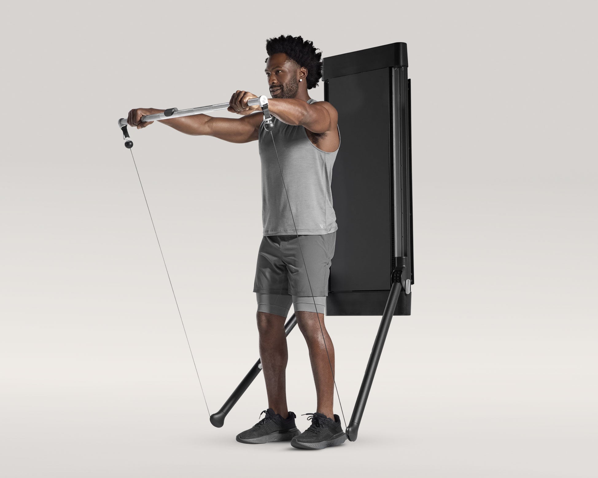 Tonal coach performing a Barbell Front Raise