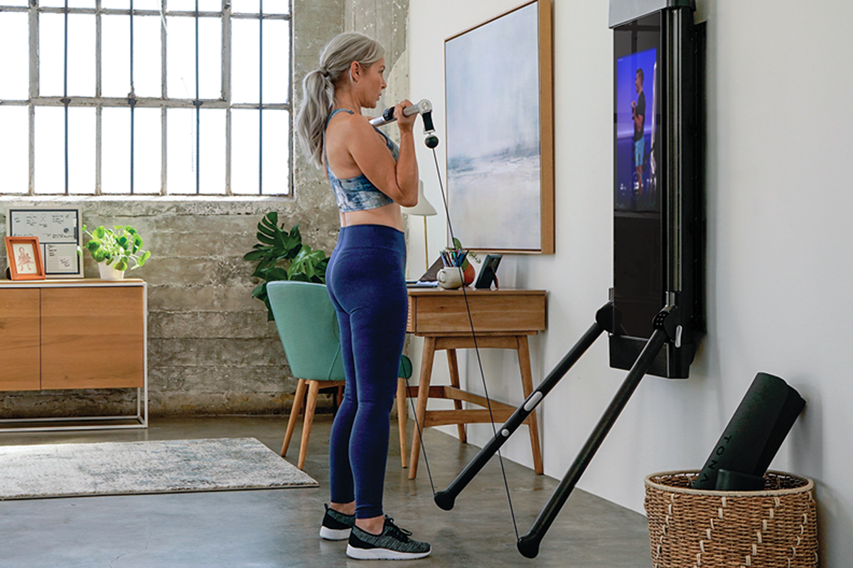 Woman lifting weights on Tonal