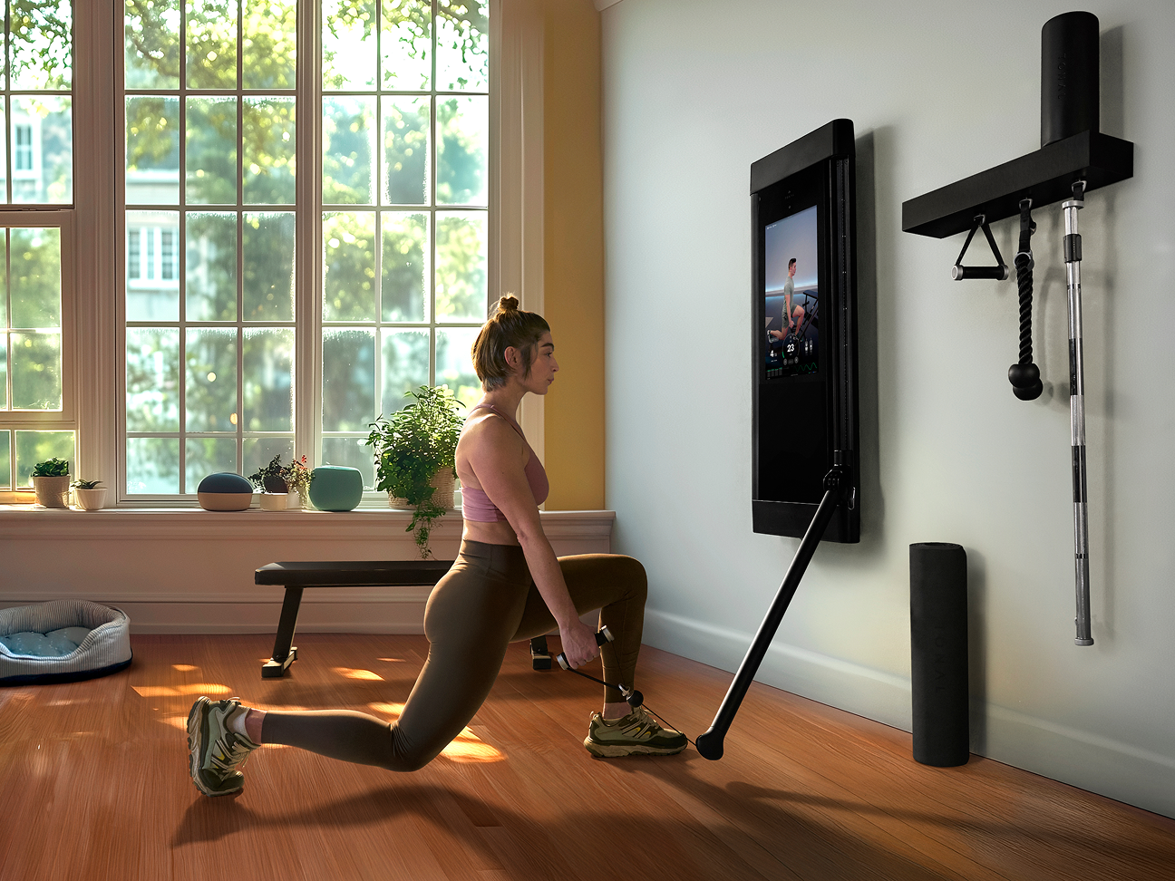 Women exercising in home using Tonal weight training machine