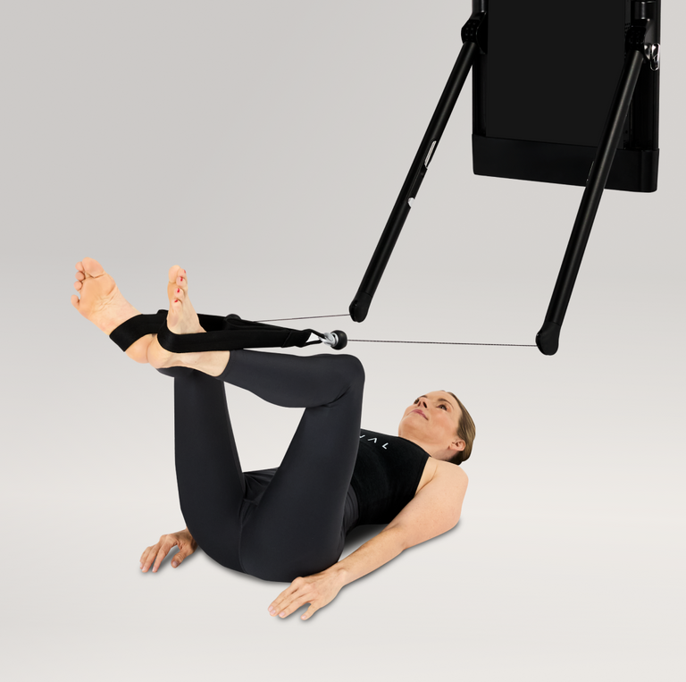Frog presses Pilates with a Tonal Machine