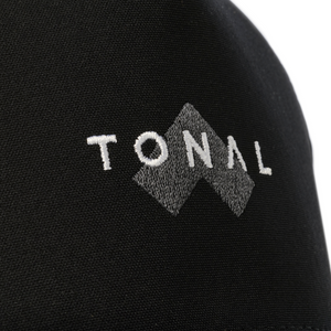 Closeup of embroidered Tonal name and logo on black hat