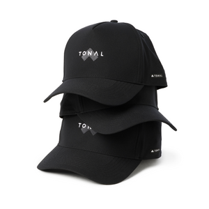 Multiple black Tonal baseball hats stacked on one another