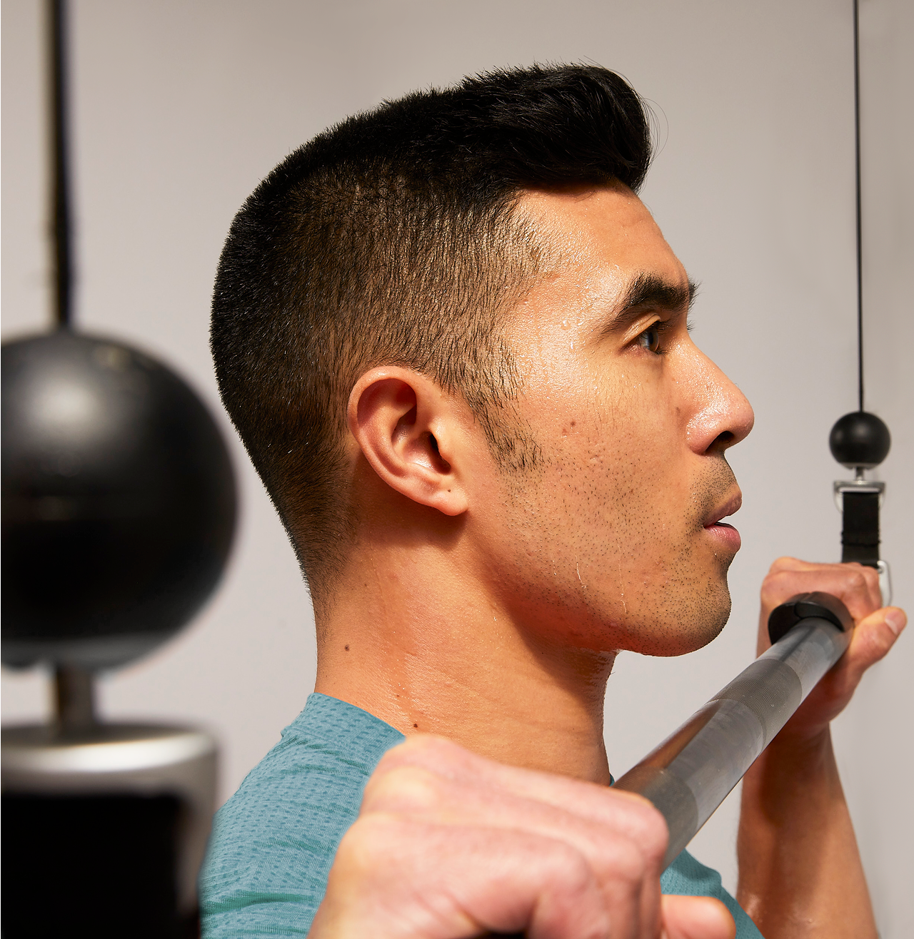 Man using Tonal barbell attachment