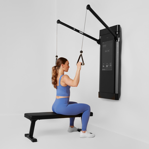 Woman exercising using Tonal smart handles with her Tonal machine