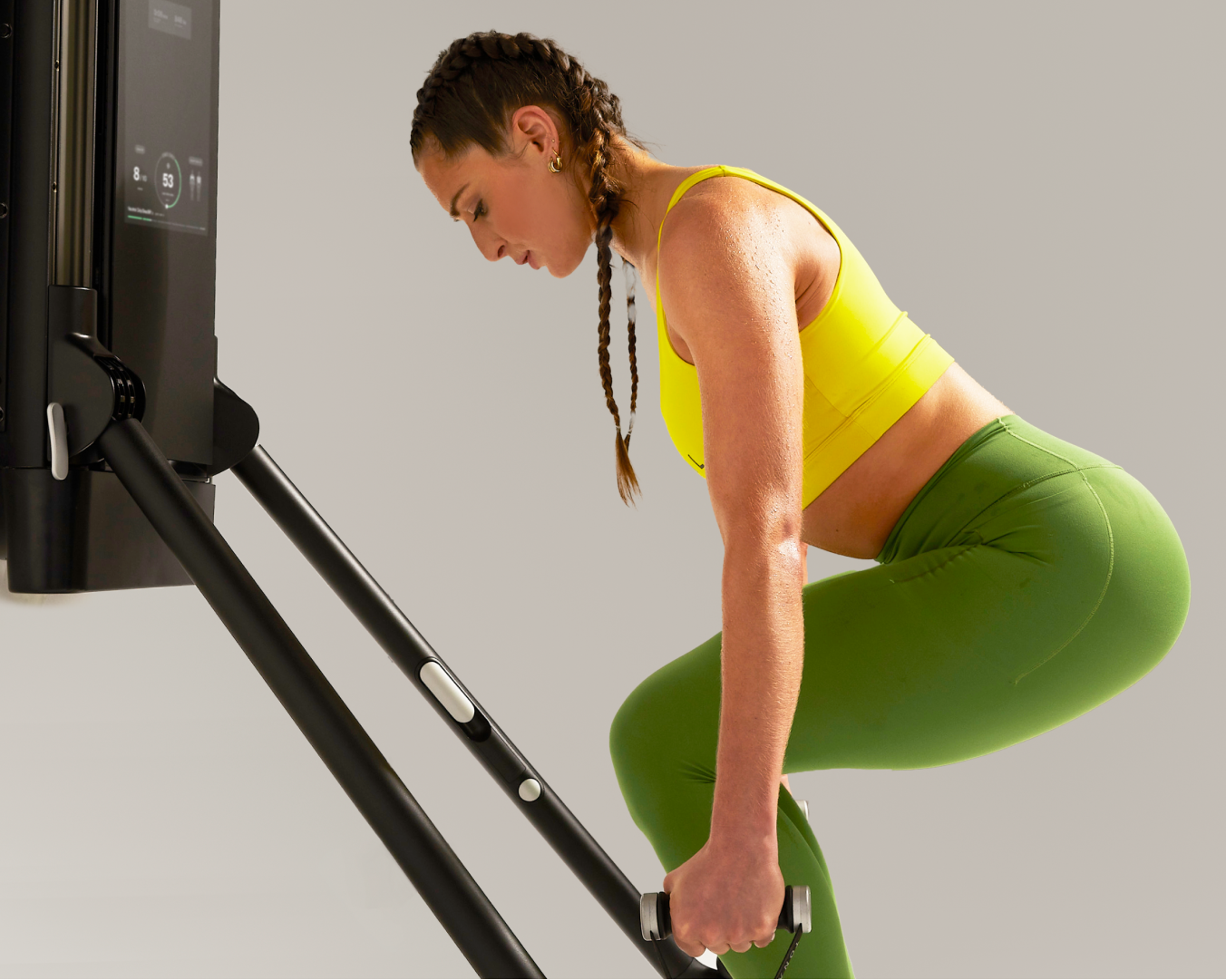 Tonal coach using a Tonal strength training system to exercise
