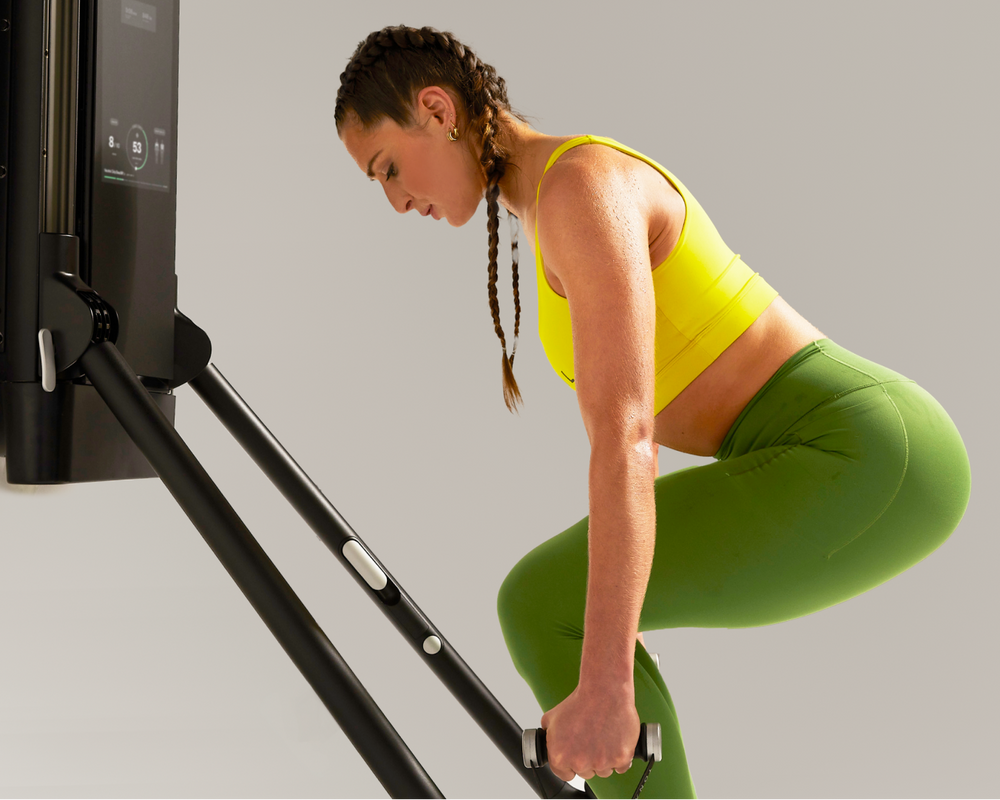 Tonal coach using a Tonal strength training system to exercise