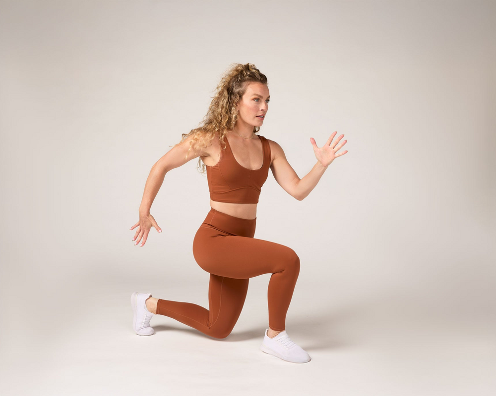 Tonal coach performing lunge bodyweight exercise 